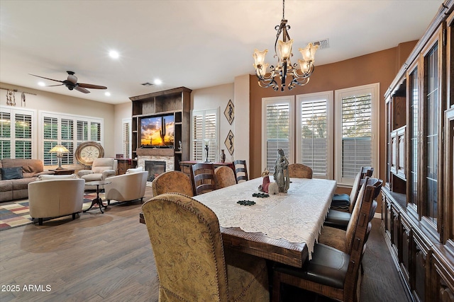 3350 S Holguin Way, Chandler, AZ 85248 - dining space featuring a chandelier, a ceiling fan, dark wood-type flooring, recessed lighting, and a stone fireplace