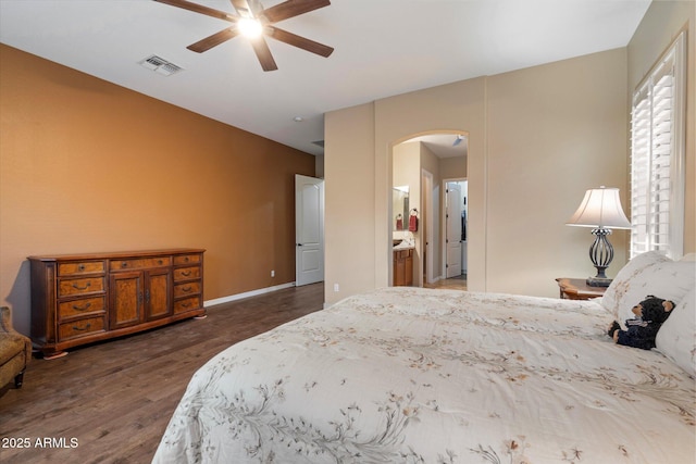 3350 S Holguin Way, Chandler, AZ 85248 - bedroom with arched walkways, wood finished floors, ensuite bath, and ceiling fan