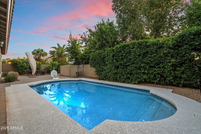 3350 S Holguin Way, Chandler, AZ 85248 - pool at dusk featuring a patio area and a fenced backyard