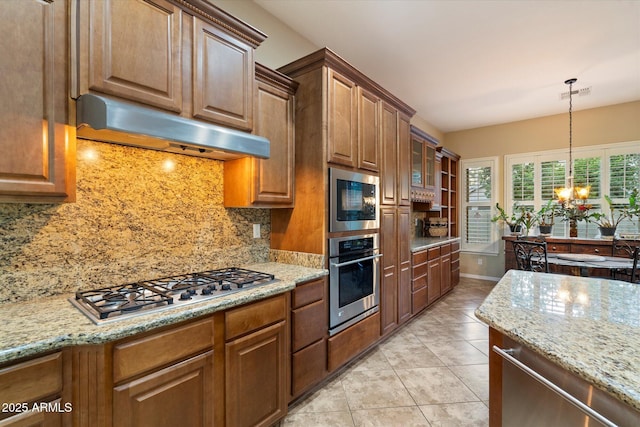 3350 S Holguin Way, Chandler, AZ 85248 - kitchen featuring stainless steel appliances, under cabinet range hood, a chandelier, and light stone countertops