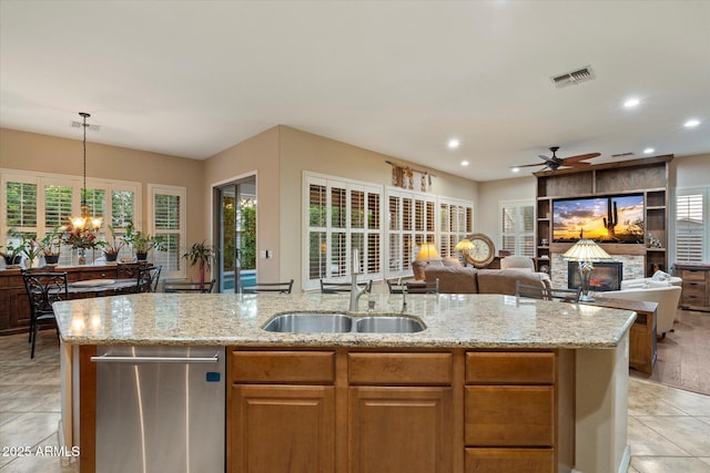 3350 S Holguin Way, Chandler, AZ 85248 - kitchen featuring a sink, light stone counters, a ceiling fan, a chandelier, and an island with sink