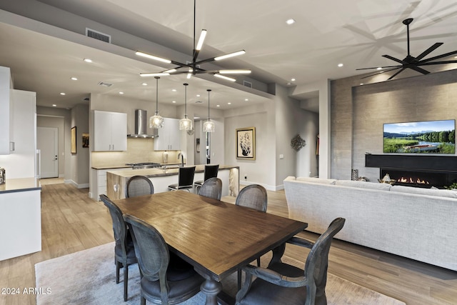 dining area featuring light hardwood / wood-style flooring and an inviting chandelier