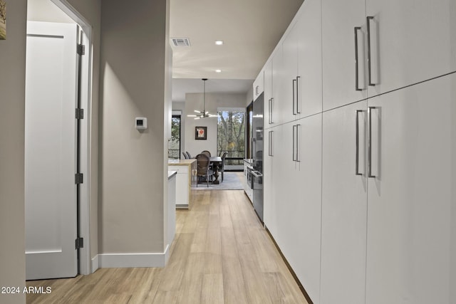 corridor with light wood-type flooring