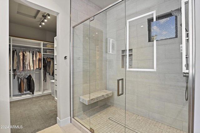 bathroom featuring tile patterned flooring and a shower with shower door