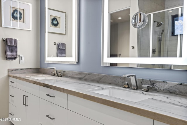 bathroom featuring vanity and a shower with shower door