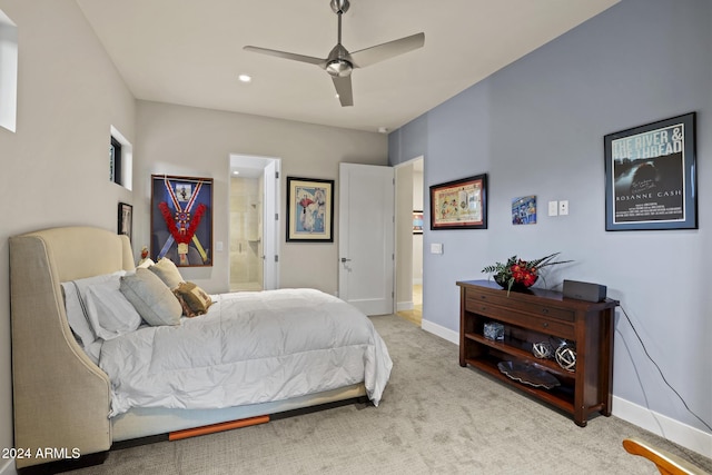 carpeted bedroom with ensuite bathroom and ceiling fan