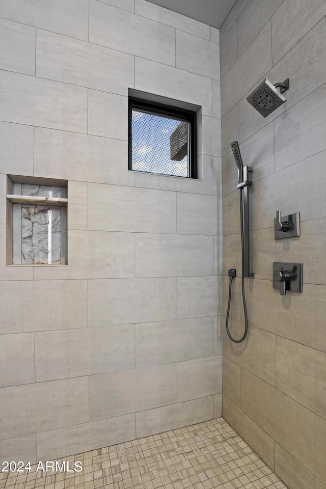 bathroom with a tile shower