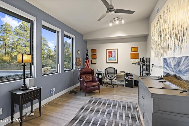 living area with light hardwood / wood-style floors and ceiling fan