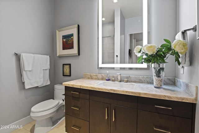 bathroom featuring tile patterned flooring, vanity, and toilet