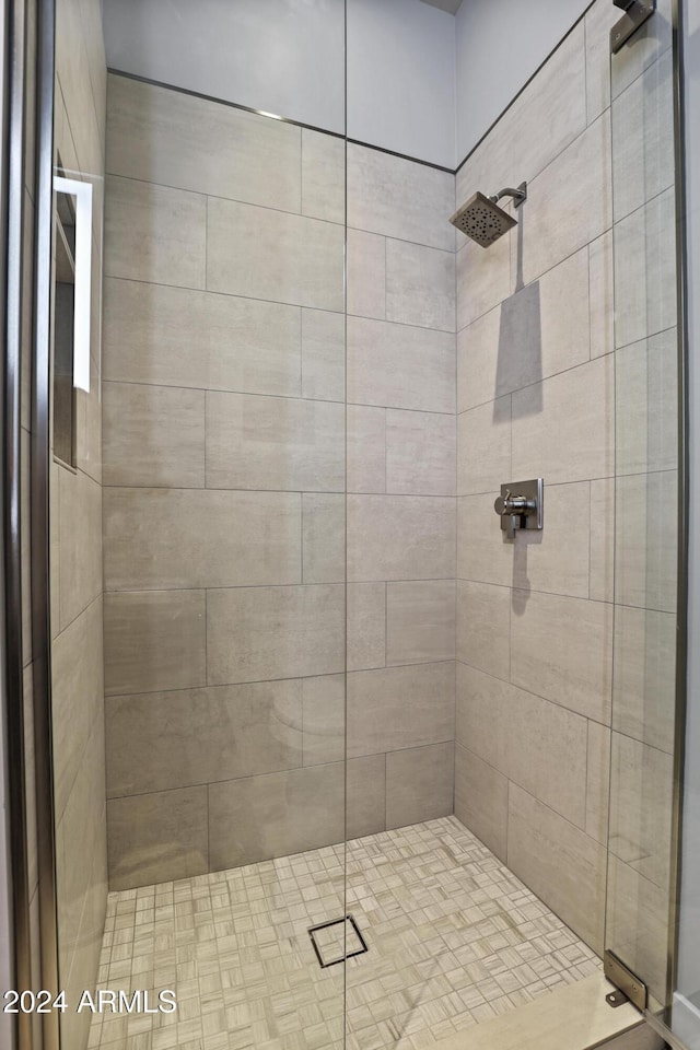 bathroom with a shower with shower door