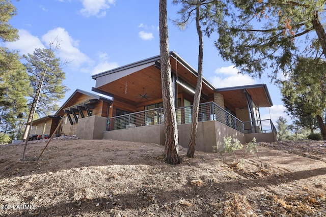 exterior space with ceiling fan