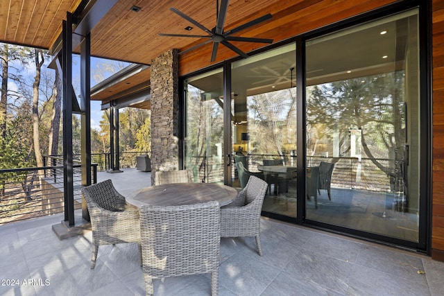 unfurnished sunroom with ceiling fan and wooden ceiling