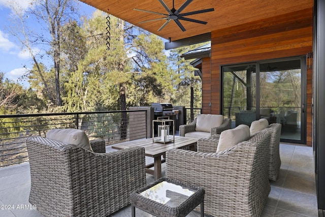 view of patio featuring ceiling fan and a balcony