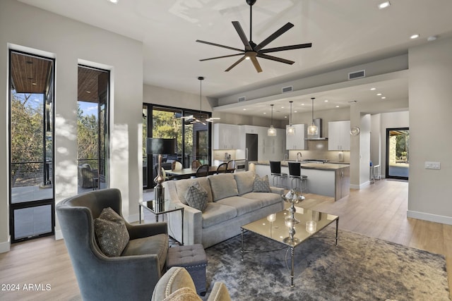 living room featuring ceiling fan and light wood-type flooring