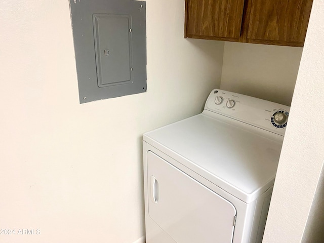 washroom featuring washer / dryer, cabinets, and electric panel