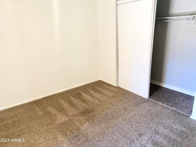 unfurnished bedroom featuring a closet and carpet floors