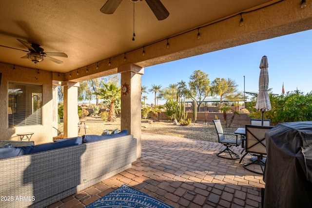 view of patio featuring area for grilling, outdoor lounge area, and ceiling fan