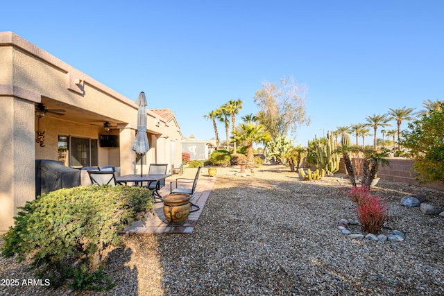 view of yard with ceiling fan and a patio area