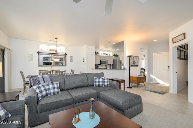 living room with light tile patterned floors, a wealth of natural light, and a chandelier