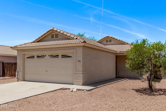 330 S Valley Dr, Apache Junction, AZ 85120 - view of front of property featuring a garage, stucco siding, a tiled roof, and concrete driveway