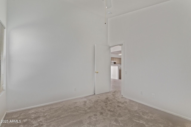 330 S Valley Dr, Apache Junction, AZ 85120 - carpeted spare room featuring baseboards, ceiling fan, and a high ceiling