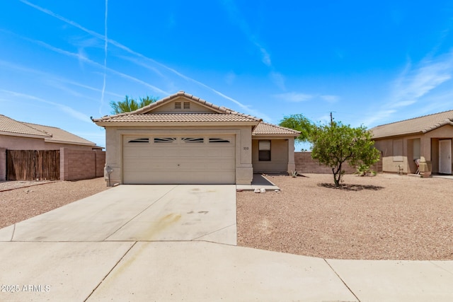330 S Valley Dr, Apache Junction, AZ 85120 - view of front facade with a tile roof, stucco siding, concrete driveway, and an attached garage
