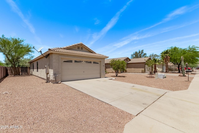 330 S Valley Dr, Apache Junction, AZ 85120 - view of front of house featuring stucco siding, driveway, a tile roof, and an attached garage