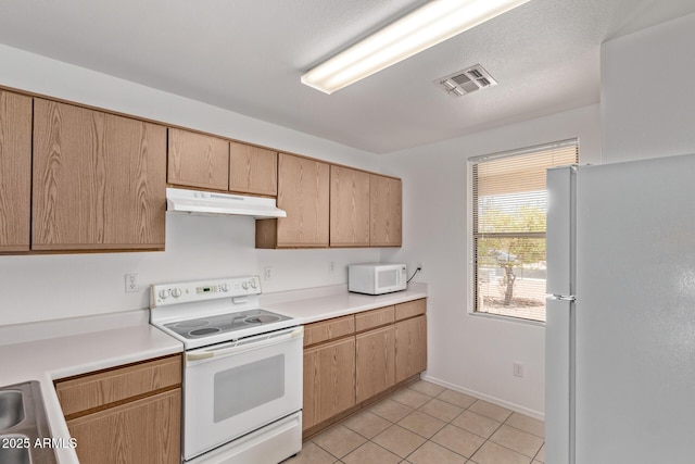 330 S Valley Dr, Apache Junction, AZ 85120 - kitchen featuring white appliances, under cabinet range hood, light countertops, light tile patterned floors, and baseboards