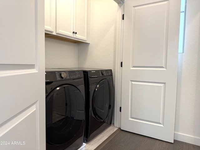 laundry room with cabinets, dark hardwood / wood-style flooring, and independent washer and dryer