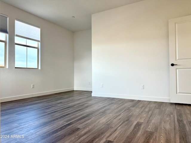 spare room with dark hardwood / wood-style flooring