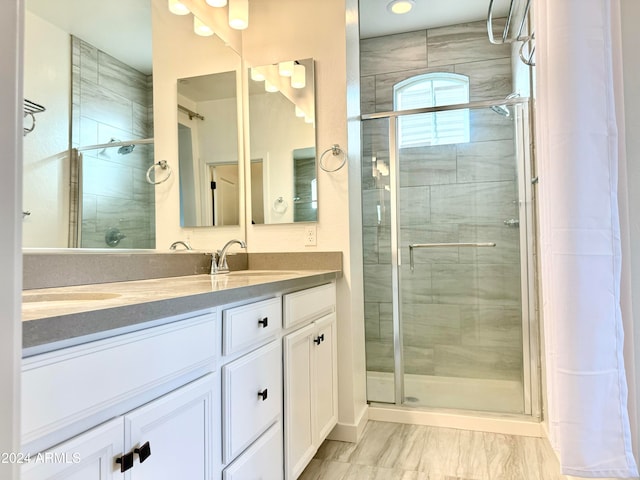 bathroom featuring walk in shower and vanity