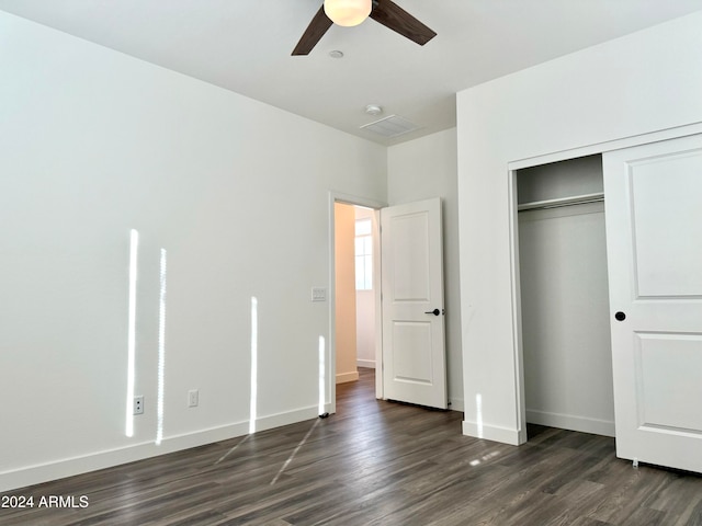 unfurnished bedroom with ceiling fan, a closet, and dark hardwood / wood-style flooring