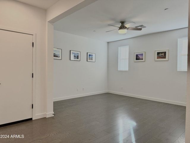 empty room featuring ceiling fan and dark hardwood / wood-style floors