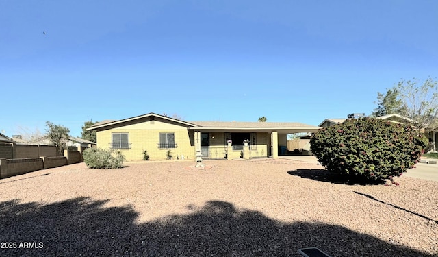 rear view of house with fence