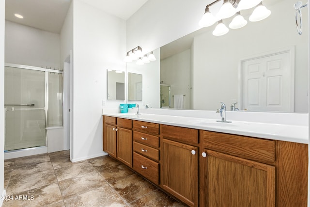 bathroom with a shower with door and vanity