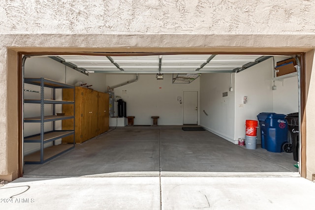 garage with a garage door opener and water heater