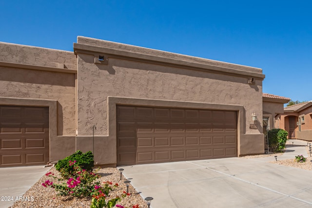 pueblo-style house with a garage