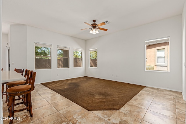 interior space with ceiling fan and light tile patterned floors