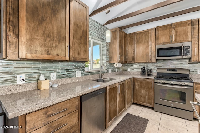 kitchen featuring appliances with stainless steel finishes, decorative backsplash, lofted ceiling with beams, light stone counters, and sink