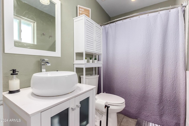 bathroom with vanity, tile patterned flooring, and toilet