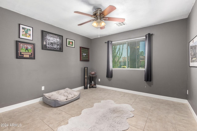 interior space with ceiling fan and light tile patterned flooring