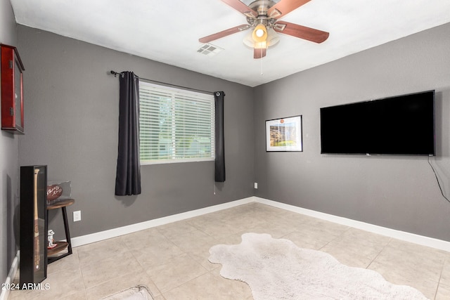 interior space featuring light tile patterned floors and ceiling fan