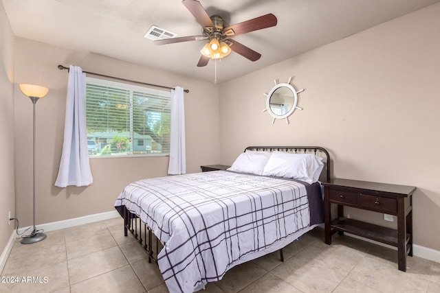 tiled bedroom with ceiling fan