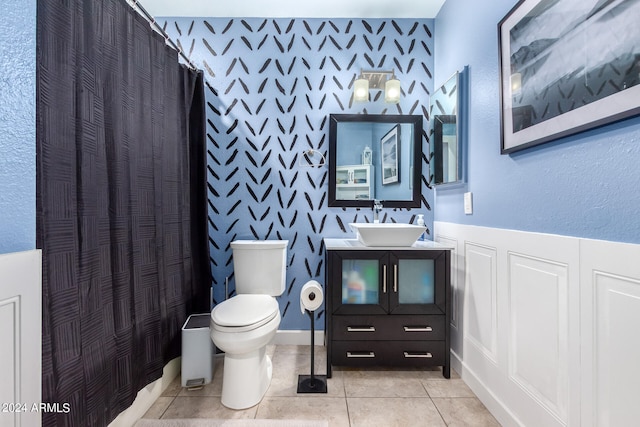 bathroom with tile patterned flooring, vanity, toilet, and a shower with shower curtain