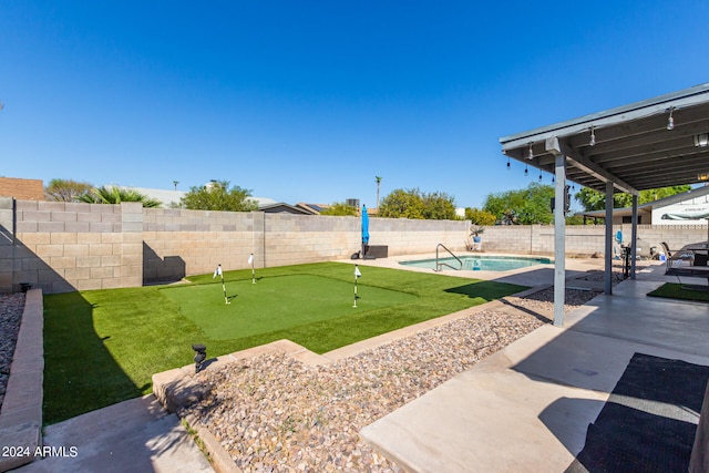 view of yard featuring a fenced in pool and a patio area