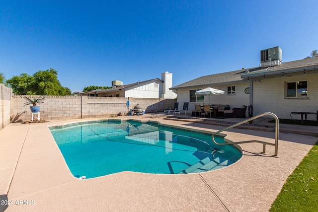 view of pool with central AC unit and a patio area