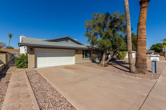 ranch-style home featuring a garage