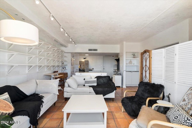 tiled living room with a textured ceiling