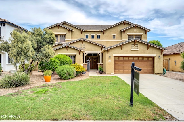 view of front of house with a garage and a front yard