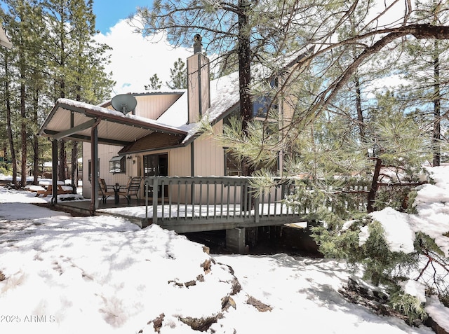 17710 S Maverick Cir, Munds Park, AZ 86017 - view of snow covered exterior with a wooden deck and a chimney